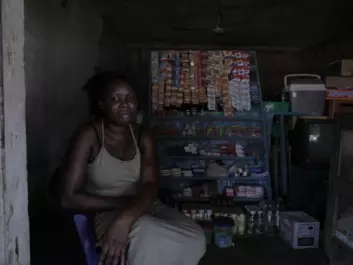 Some women start up small businesses in the hope that they support their families. Here "Esther" is in her little kiosk funded by an Italian NGO which helps repatriated African women. (Photo: Janus Metz)