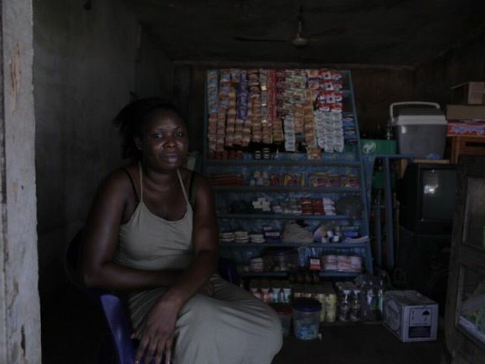 Some women start up small businesses in the hope that they support their families. Here 'Esther' is in her little kiosk funded by an Italian NGO which helps repatriated African women. (Photo: Janus Metz)