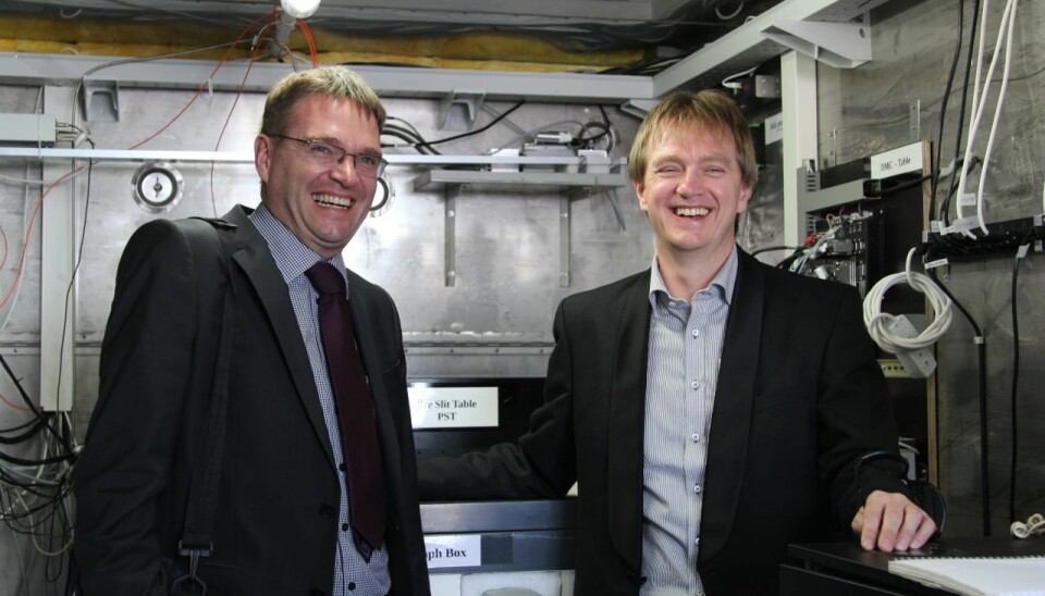 Professor Hans Kjeldsen (left) and Associate Professor Frank Grundahl, are both from Stellar Astrophysics Centre in Aarhus. Here they are happily showing one of the telescope's instruments - the spectrograph, which is used to measure starquakes. (Photo: Lise Brix).