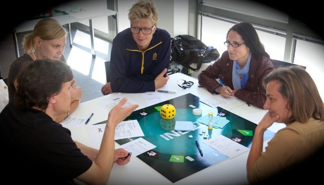 It resembled a proper game, but in reality the board, cards, and pieces are entirely superfluous. Nonetheless, the players engaged whole-heartedly – and enjoyed every bit of it. (Photo: Interacting Minds Center) It resembled a proper game, but in reality the board, cards, and pieces are entirely superfluous. Nonetheless, the players engaged whole-heartedly – and enjoyed every bit of it. (Photo: Interacting Minds Center)