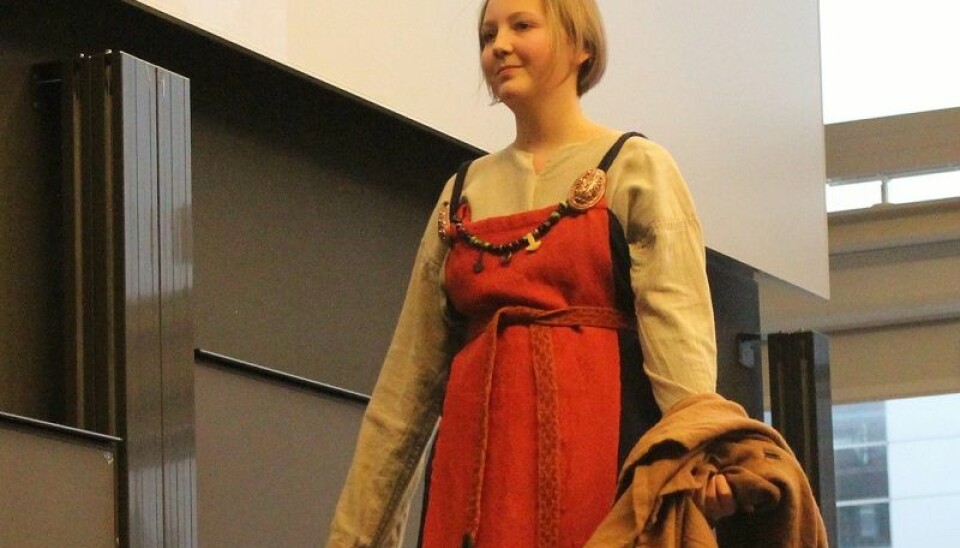 A complete female outfit in one of the Viking's most stylish colours, red. Shell-shaped brooches hold the dress in place. These went out of fashion midway through the Viking Age. (Photos by Johan Skov Andersen)