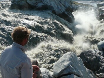 A scientist watches melt water drain from the Russell glacier catchment in Greenland. Scientists do not yet know just how often these rapid melt events may occur in the future as the earth warms and Greenland receives more rain. (Photo: Sam Doyle) A scientist watches melt water drain from the Russell glacier catchment in Greenland. Scientists do not yet know just how often these rapid melt events may occur in the future as the earth warms and Greenland receives more rain. (Photo: Sam Doyle)