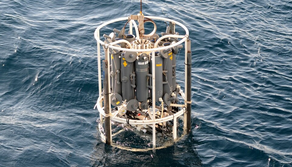 A water sampling rig loaded with cannisters is lowered into the sea. On-board sensors measure temperature and pressure so that Stedmon and his team know when they have reached the desired depth for sampling. They then close the canisters and raise the rig. (Photo: Thomas Juul Pedersen)