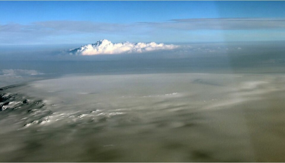 Day 55: The eruption continues. Bárdarbunga caldera in the foreground, looking towards the northeast. The eruption column is seen rising through cloud in the distance, 24 October 2014 (Thórdís Högnadóttir)