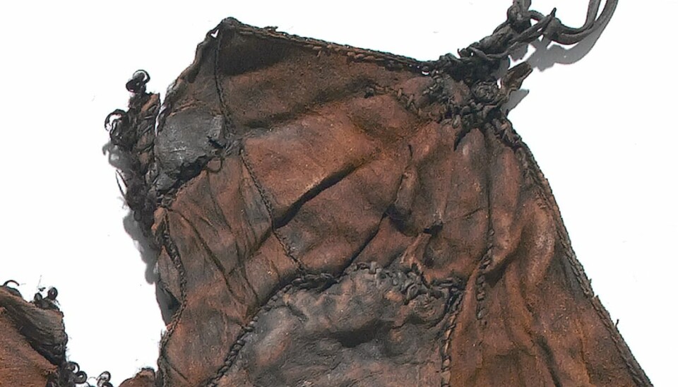 Details of the under-cloak found in Huldre Fen show the original seam and a repair. (Photo: Roberto Fortuna, 2006)