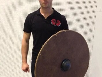 Warming with his reconstruction of a Viking round shield. (Photo: Johanne Kusnitzoff) Warming with his reconstruction of a Viking round shield. (Photo: Johanne Kusnitzoff)