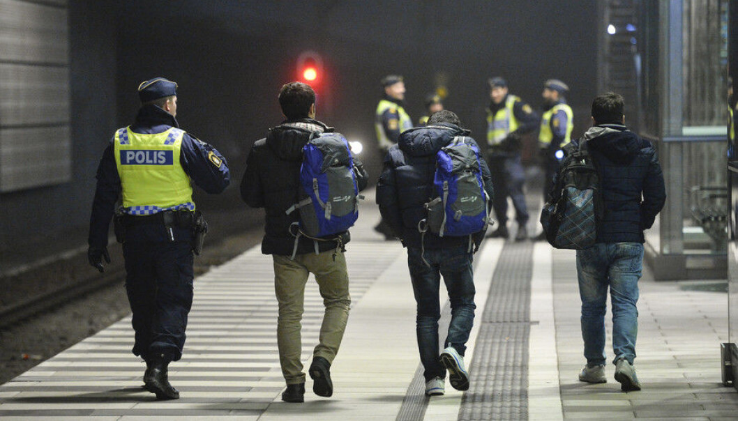 A police officer escorts migrants from a train at Hyllie station outside Malmo. (Photo: TT News Agency/Reuters) A police officer escorts migrants from a train at Hyllie station outside Malmo. (Photo: TT News Agency/Reuters)