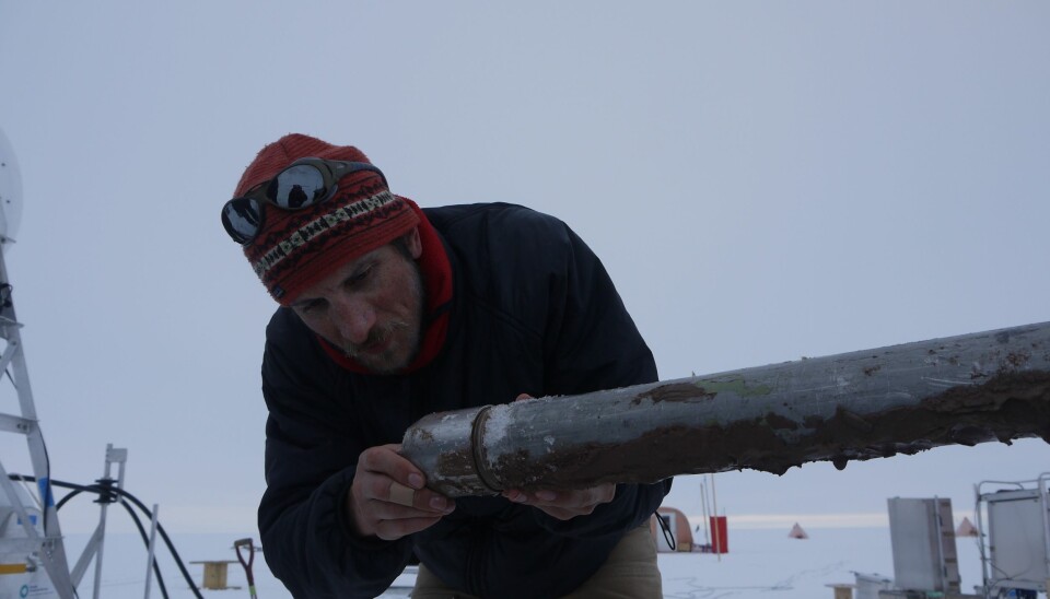 Lead-author James Smith, pictured here with one of the sediment cores. “It was a real race against time to do everything as the hole was refreezing and shrinking the entire time,” he says. (Photo: M. Brian)