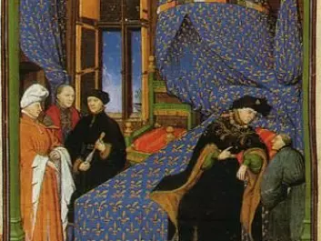 Illustration from Pierre Salmon’s “Dialogues”. The author sits at the foot of Charles VI. (Photo: Wikimedia)