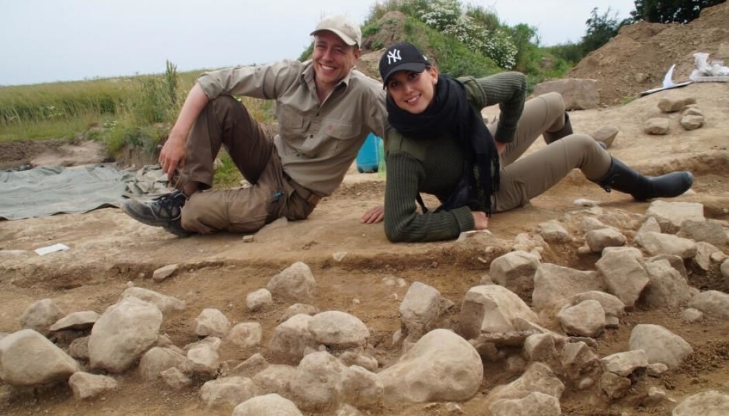 Archaeologists pose behind the newly discovered cup marked petroglyphs (the stones with rounded indents) on the Danish island Bornholm. (Photo: Melissa Cherry Villumsen, archaeology student at the University of Copenhagen, Denmark) Archaeologists pose behind the newly discovered cup marked petroglyphs (the stones with rounded indents) on the Danish island Bornholm. (Photo: Melissa Cherry Villumsen, archaeology student at the University of Copenhagen, Denmark)