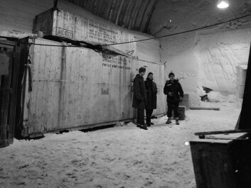 Danish and American Scouts Søren Gregersen and Kent Goering overwintered in the Camp in 1960, stand in front of a part of the nuclear reactor, packed away in boxes. (Photo: US Army) Danish and American Scouts Søren Gregersen and Kent Goering overwintered in the Camp in 1960, stand in front of a part of the nuclear reactor, packed away in boxes. (Photo: US Army)