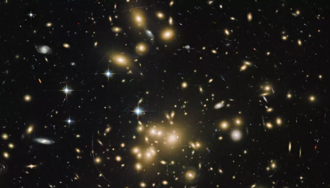 The Abell 1689 cluster galaxy contains about a thousand galaxies and trillions of stars. By studying images of galaxy clusters, scientists have calculated that dark matter makes up approximately 23 per cent of all matter and energy in space (Credit: NASA/ESA/STScI/AURA/Dominion Astrophysical Observatory/JHU/J. Blakeslee and H. Ford)