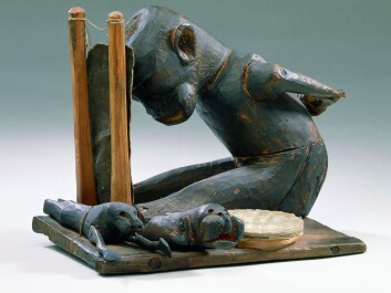 A carved wooden figure from eastern Greenland, representing an angakoq or shaman. He is tied up and about to leave on a spiritual journey. At the side of the angakoq are assisting spirits and the drum, which will make him enter a trance. Therkel Mathiassen collected the figure in 1932. (Photo: A. Mikkelsen, National Museum of Denmark) A carved wooden figure from eastern Greenland, representing an angakoq or shaman. He is tied up and about to leave on a spiritual journey. At the side of the angakoq are assisting spirits and the drum, which will make him enter a trance. Therkel Mathiassen collected the figure in 1932. (Photo: A. Mikkelsen, National Museum of Denmark)