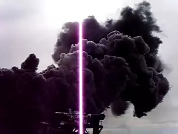 Measuring the heat flow from IDDP-1 at Krafla. The steam is black because it loosens compounds of iron, sulphur and oxygen from corroded parts of the drill string. (Photo: From a video made by IDDP)