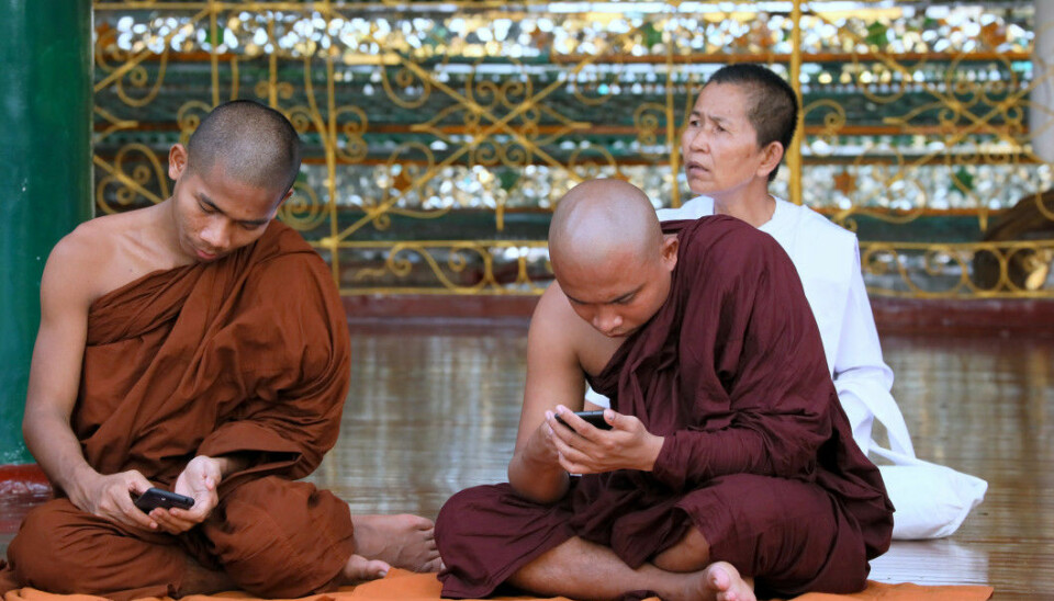 Monks checking their phones i Myanmar. Facebook was integral in spreading disinformation that facilitated the Rohingya-genocide in Myanmar. (Photo: Shutterstock)