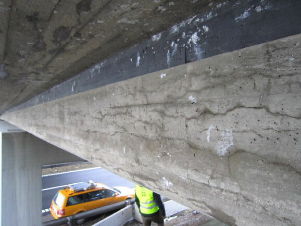 the underside of a bridge, showing cracks in the concrete