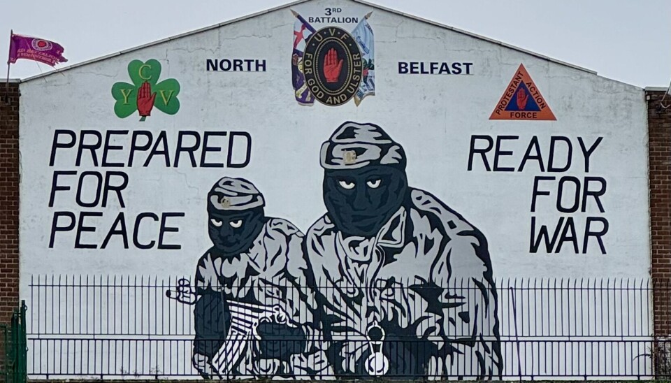 Loyalist mural in Belfast which features two masked, heavily armed men and reads: “Prepared for peace, ready for war'. (Photo: Virtual Belfast Tour)