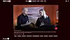 A screenshot from a streaming service showing a video of two people in a warmly lit room.